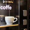 Coffee machine in Ghaziabad with white cup on drip tray preparing fresh coffee