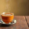 Freshly brewed coffee in a glass cup with saucer by coffee machine wholesaler Ghaziabad
