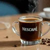 Nescafe coffee Online in Noida clear glass cup filled with brewed coffee on wooden table