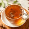 Nestea Masala Gold Tea Premix Ghaziabad served in clear glass cup with star anise garnish