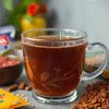 Best tea premix suppliers Noida clear glass cup filled with hot brewed tea on a table