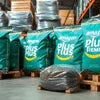 Bulk tea premix suppliers near me with green packaging bags stacked in warehouse ready for distribution