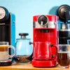 Red coffee vending machines for small businesses with coffee cups and French press on wooden counter