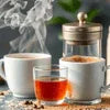 Atlantis Kadak Tea Premix Supplier Gurugram steaming cup of tea with French press and coffee cup