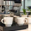 Tea coffee machine rental Gurugram with dual spout brewing fresh coffee in white cups