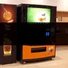 Automatic tea coffee machines Gurugram modern black and orange vending machine in office setting