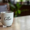 Cafe Desire Tea Coffee Premix served in a white coffee cup with steam rising on wooden table