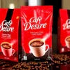 Cafe Desire Low Sugar Coffee Premix red packets with coffee beans background