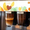 Cafe Desire Premix espresso and black coffee served in glass cups on a colorful background