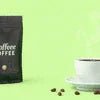Cafe Desire coffee premix refill pack Noida with white coffee cup and scattered coffee beans