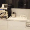 Coffee vending machine for rent setup with coffee cups and accessories on a white counter