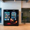 Nescafe coffee vending machine with various drink options in modern office lounge area