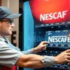 Atlantis tea coffee vending machine Nescafe brand dispensing coffee to customer