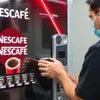 Nescafe vending machine dispensing coffee in an office using Atlantis vending machine for office