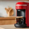 Atlantis coffee machine Ghaziabad red single-serve brewing coffee cup on counter