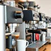 Coffee premix machine shop near Sector 106 Delhi with multiple espresso machines and fresh coffee cups