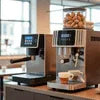 Modern coffee machine Sector 62 with touchscreen interface brewing fresh coffee in cafe setting
