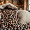 Coffee beans spilling from burlap sacks at a coffee machine supplier warehouse