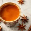 Tea premix in Noida served in a cup with star anise and cinnamon for flavor