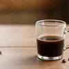 Buy instant coffee 500g pack Noida with rich dark brewed coffee in glass cup on wooden table