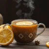 Cardamom chai near Sector 150 Noida served in a glass cup with lemon slice and spices