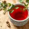 immunity tea in Noida Sector 143 served in ceramic cup with fresh herbs on wooden table