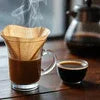 Tea premix for offices in Noida served in glass with steaming hot tea and coffee cup on wooden table