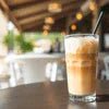 Atlantis tea coffee machine Connaught Place iced coffee glass on table in café setting