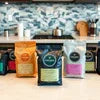 Atlantis vending machine setup in Delhi with four different coffee premixes on a kitchen counter