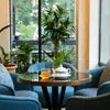 Atlantis coffee premix shop Noida cozy seating area with table and chairs near window