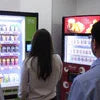 Atlantis vending machine technical support assisting customers using snack and drink vending machines