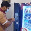 Man using a vending machine to buy Atlantis tea premix near me Sector 71 Noida