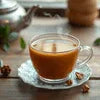 Atlantis cardamom tea premix in Ghaziabad served in a clear glass cup with a saucer