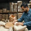 Coffee powder supplier in Noida packaging fresh coffee powder in sacks at warehouse