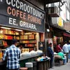 Local coffee powder distributor shop with shelves stocked and customers buying coffee