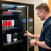 Coffee vending machine maintenance tips with technician servicing automatic coffee dispenser