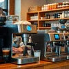 Coffee machines displayed in a cafe representing coffee machine suppliers Noida
