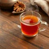 Jaggery tea premix for offices cup of hot tea with star anise on wooden table
