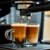 DeLonghi espresso machine brewing double shot for office coffee