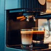 Best coffee machine in Sector 62 Gurugram preparing fresh espresso shots with dual small glasses