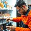 Technician repairing coffee vending machine using vending machine spare parts Gurugram