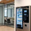 Coffee vending machine with multiple beverage options in modern office breakroom