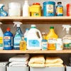 Various housekeeping chemicals Noida displayed on shelves with cleaning solutions and towels