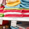 Microfiber cleaning cloth Noida stacked in various colors on retail shelves