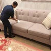 Odour eliminator Noida brand used for cleaning and freshening upholstery on beige sofa