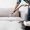 Professional sofa cleaning using best sofa cleaning services Noida equipment on light grey upholstery