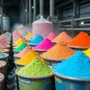 Colorful powdered detergents displayed in containers by bulk detergent suppliers Noida