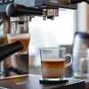 Coffee machine brewing espresso shot for vending service in a cafe setting