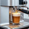 Automatic espresso machine for office near me pouring coffee into a glass cup