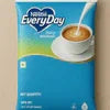 NESTELE WHITNER powder packet with coffee cup and spoon on blue background